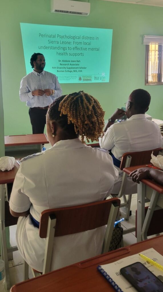 Nurses in a lecture room with a Dr. standing at the front speaking