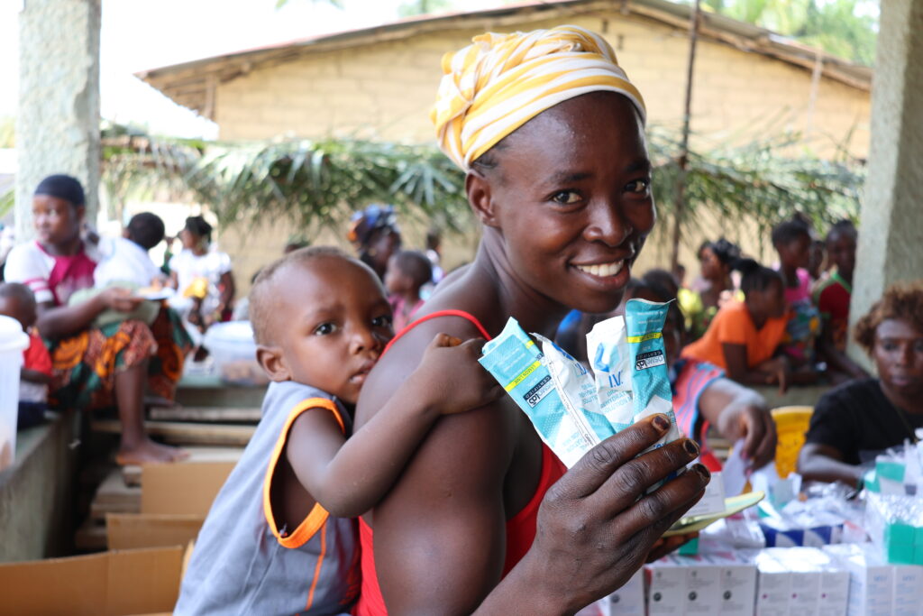 Woman smiling with baby on her back