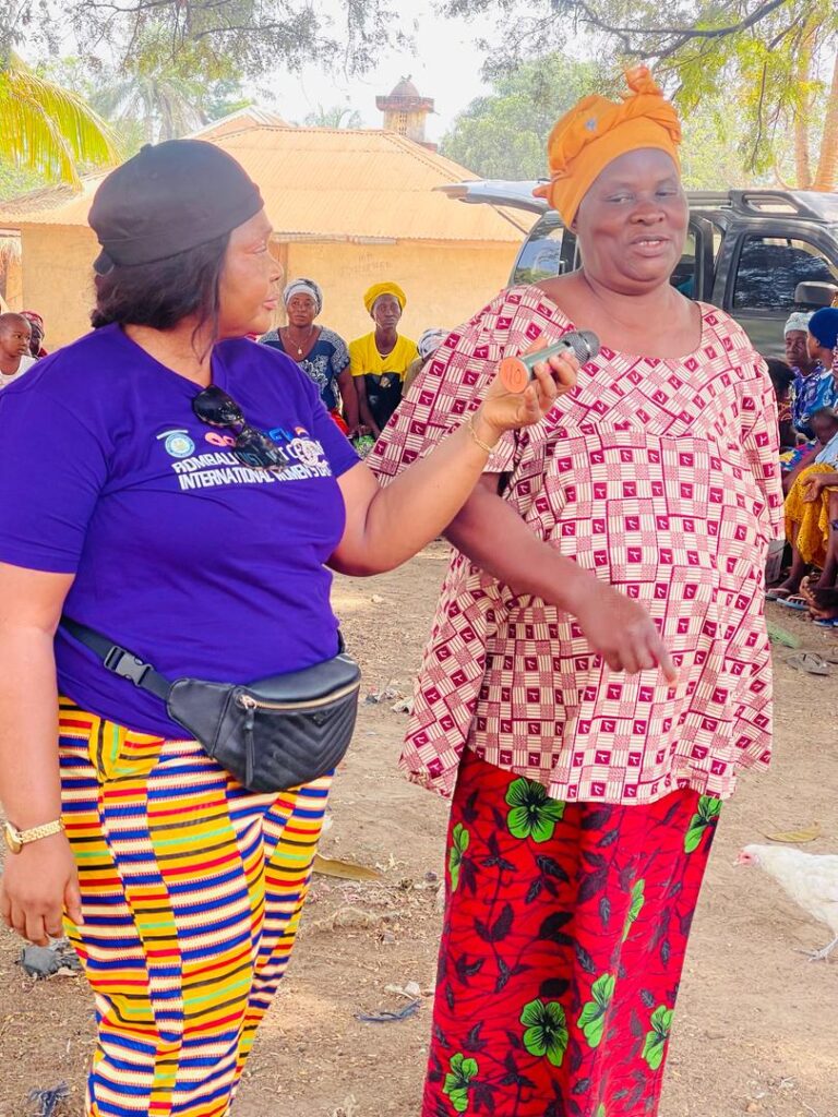 Two women standing one is interviewing the other