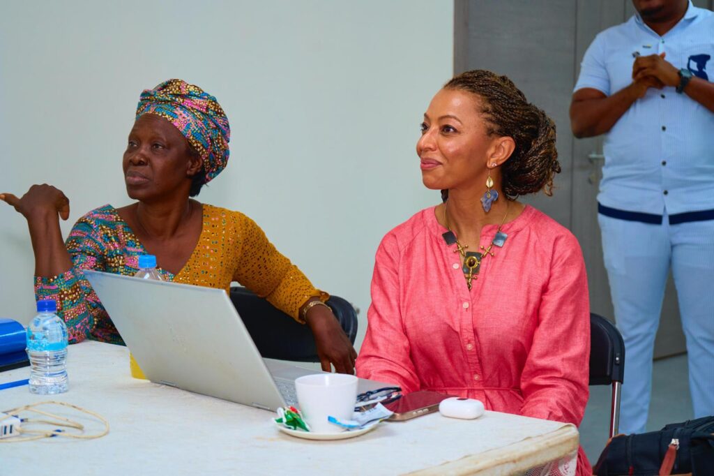 Two women sitting at a table listening