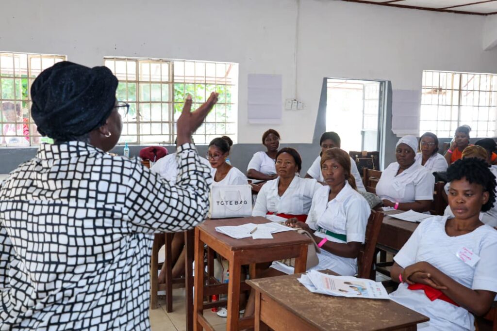 Women in front of students teaching