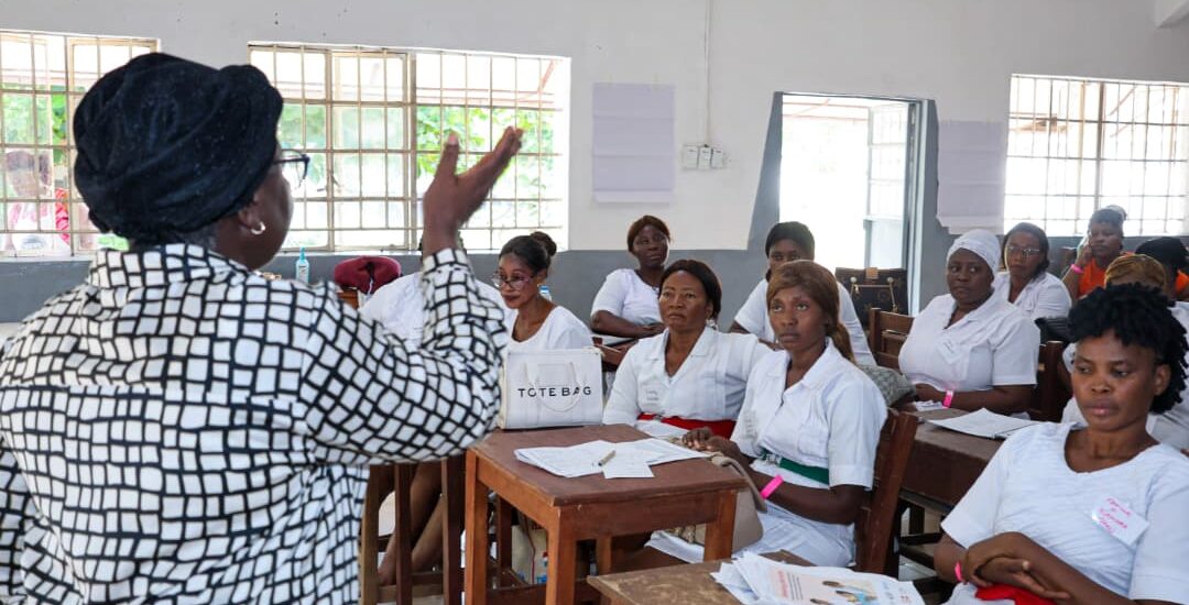 Women in front of students teaching
