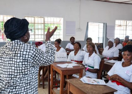 Women in front of students teaching